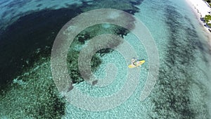 Young caucasian couple kayaking in sea at Maldives