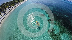 Young caucasian couple kayaking in sea at Maldives