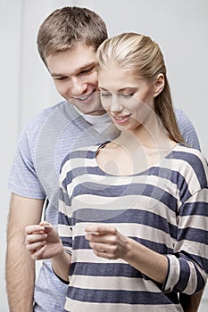 Young caucasian couple looking at Pregnancy Test