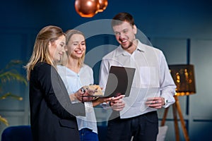 Young caucasian couple during meeting with realtor, interior designer, decorator.