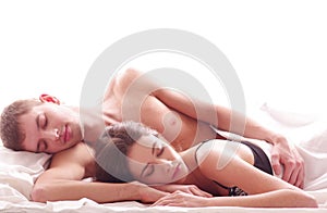 A young Caucasian couple sleeping in the bed