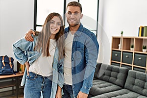 Young caucasian couple smiling happy standing at home