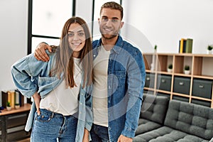 Young caucasian couple smiling happy standing at home