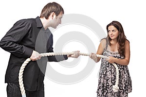Young Caucasian Couple Towing a Rope To Each Other. Concept of Separation and Divorce
