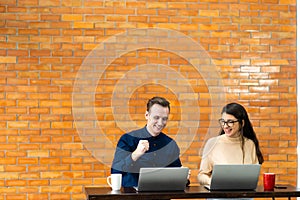 Young caucasian couple using laptop computer at home..shopping online at home. couple planning a trip abroad on their wedding