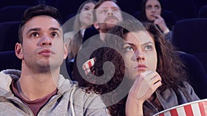 Couple watches horror at the movie theater