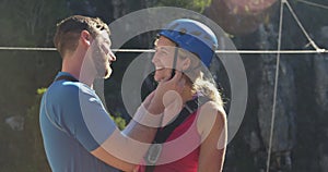 Young Caucasian couple in zip lining equipment