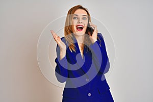 Young caucasian elegant business woman talking on the phone over isolated background very happy and excited, winner expression