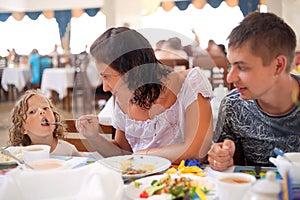 Young caucasian family having dinner together