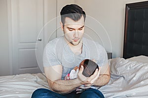 Young Caucasian father dad with his newborn mixed race Asian Chinese baby