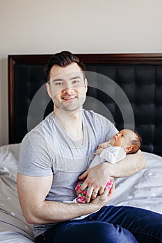 Young Caucasian father dad with his newborn mixed race Asian Chinese baby