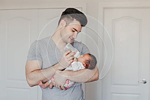 Young Caucasian father dad with his newborn mixed race Asian Chinese baby