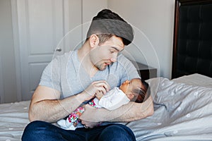 Young Caucasian father dad with his newborn mixed race Asian Chinese baby