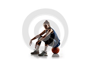 Young caucasian female basketball player against white studio background