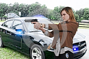 Young caucasian female detective holding up a pistol near her police car