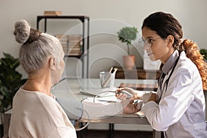 Female doctor examine elderly woman patient in hospital