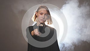 Young caucasian female feminist stand holding bat isolated in smoky space.