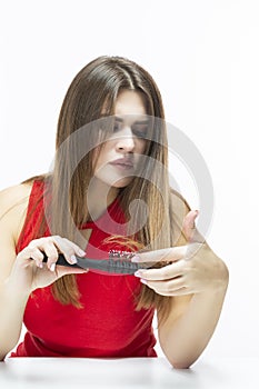 Young Caucasian Female Having Hair Problems. Checking Hair in Hairbrush