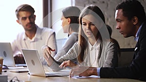 Young caucasian female worker mentor helping male african american intern