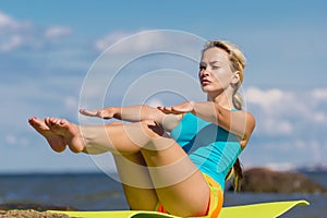 Young caucasian fitness woman practicing yoga