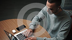 Young caucasian freelancer man working on computer at home.Young male professional using computer sitting at home