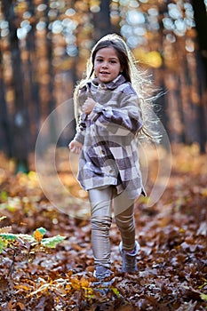 Young caucasian girl, candid autumnal portrait in the forest