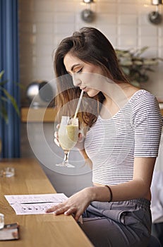 Young Caucasian girl drinking milkshake