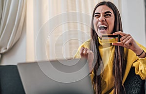 Young caucasian girl, laughing loudly, excited about a purchase