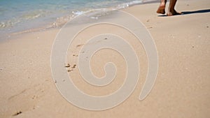 Young Caucasian Girl Leaving Footprints in the White Sand of a Tropical Beach In Thailand. HD Slowmotion.