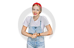 Young caucasian girl wearing casual clothes with hands together and crossed fingers smiling relaxed and cheerful