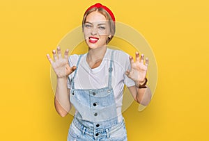Young caucasian girl wearing casual clothes smiling funny doing claw gesture as cat, aggressive and sexy expression