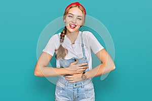 Young caucasian girl wearing casual clothes smiling and laughing hard out loud because funny crazy joke with hands on body