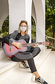 Young Caucasian Girl Wearing White Face Mask, Plays Red Guitar, Mockup