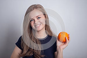 Young caucasian girl woman with orange in hands, healthy lifestyle