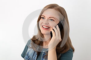 Young caucasian girl woman is talking on the mobile phone and smiling