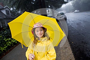 Young caucasian girl with yellow umbrella