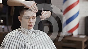 Young caucasian guy in barbershop