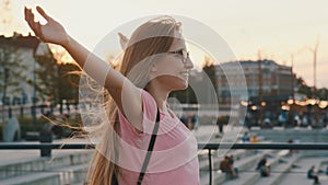 Young caucasian long hair woman with outstretched hands enjoying freedom