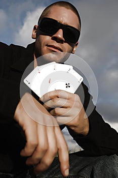 Young caucasian man with ace cards