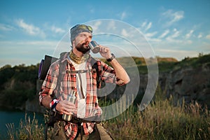 Young caucasian man with backpack resting and