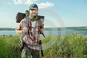 Young caucasian man with backpack walking on the