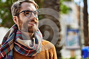 Young caucasian man with beard wearing glasses outdoors on a sunny day