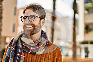 Young caucasian man with beard wearing glasses outdoors on a sunny day