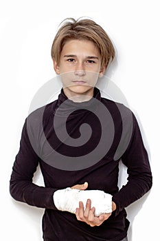 Young caucasian man with a broken arm wearing an arm splint isolated on white background