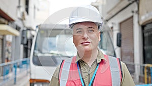 Young caucasian man builder wearing hardhat with serious face at construction place