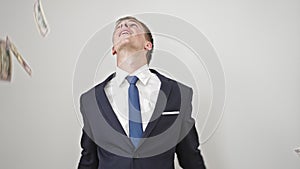 Young caucasian man business worker throwing dollars over isolated white background