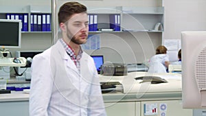 Man comes to the monitor at the laboratory