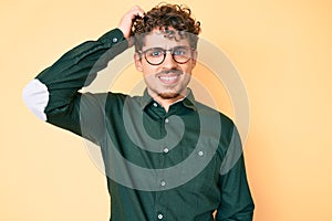 Young caucasian man with curly hair wearing casual clothes and glasses confuse and wonder about question
