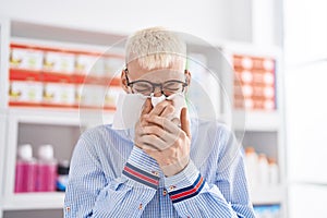 Young caucasian man customer using napkin at pharmacy