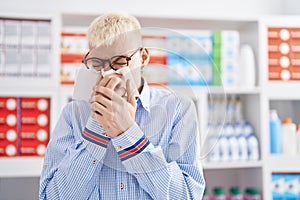 Young caucasian man customer using napkin at pharmacy